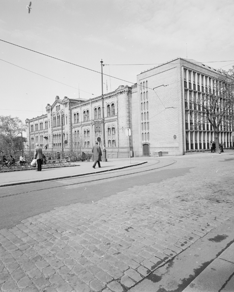 Svart Hvitt bilde av Stortinget der man ser den tradisjonelle og den modernistiske delen sammen. Foto.