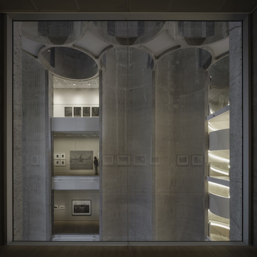 Utsikt fra et rom i kunstsiloen inn i et større atriumrom. Foto, interiør.