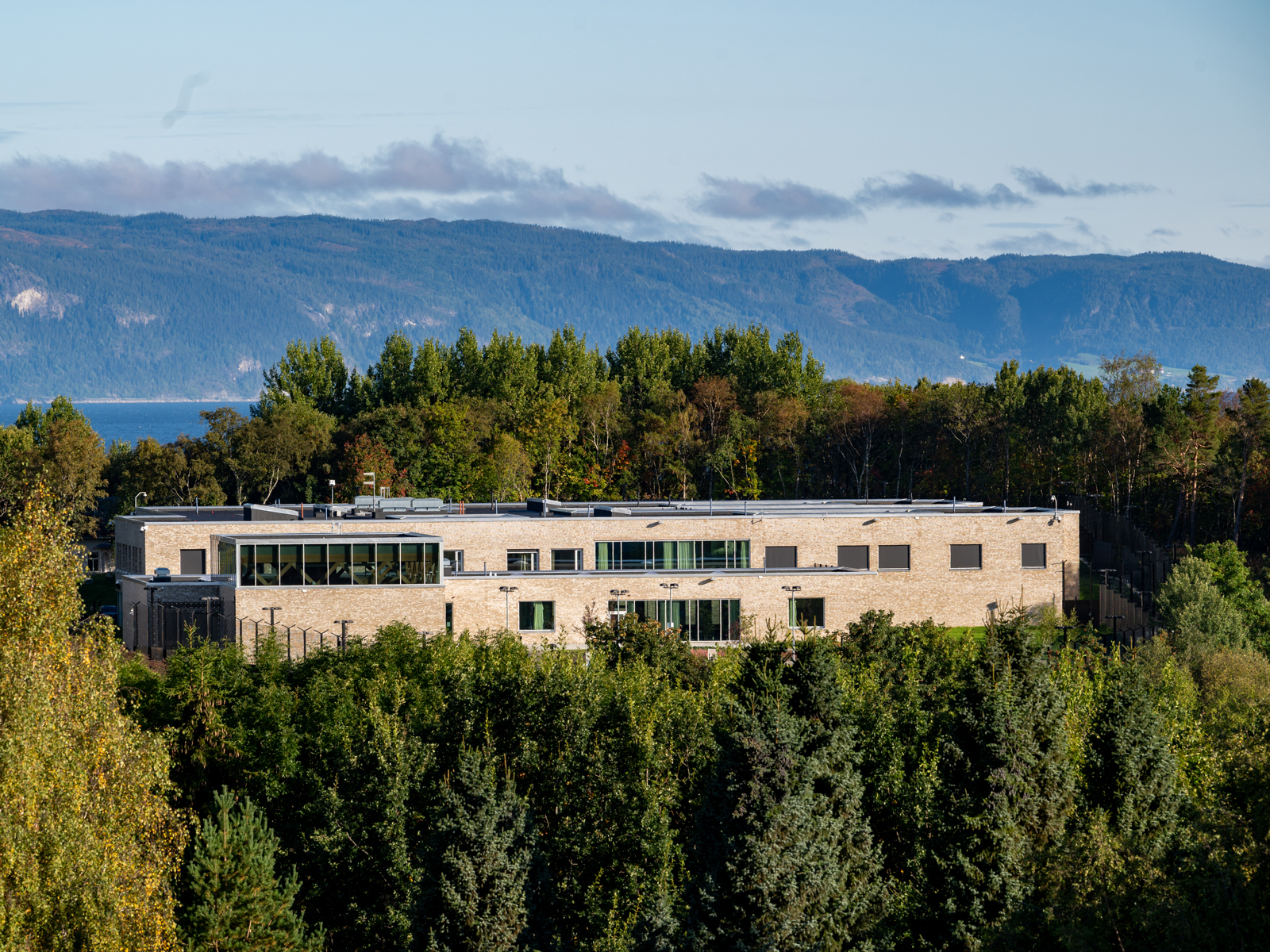 Drone foto av et bygg midt i skogen.