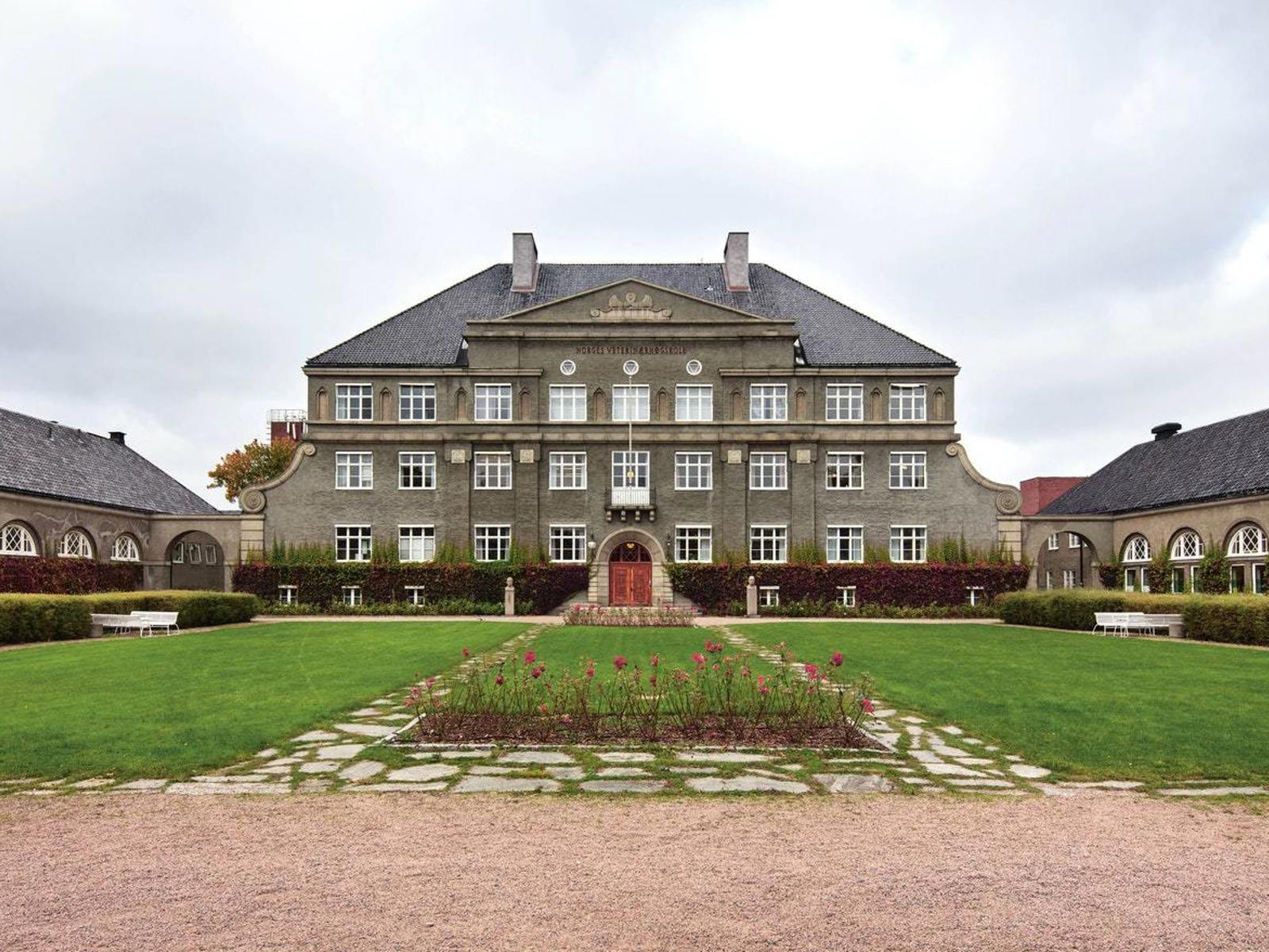 Tradisjonelt stort bygg med stor hage fremfor. Foto.