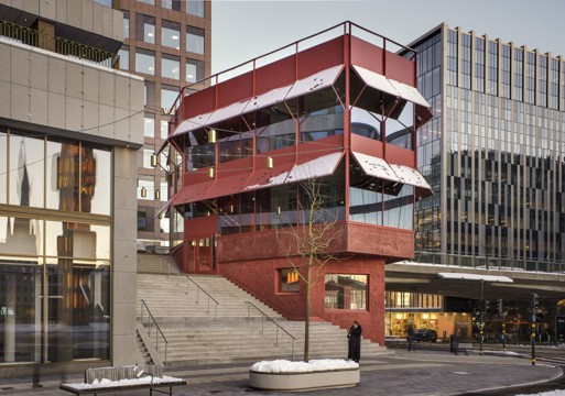 Foto av en fleretasjers rød paviljong i bysetting.