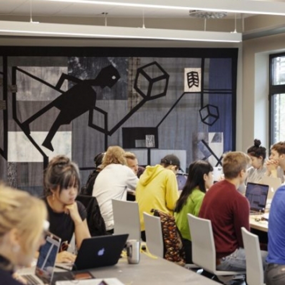 Arkitekturstudenter som sitter på datamaskiner