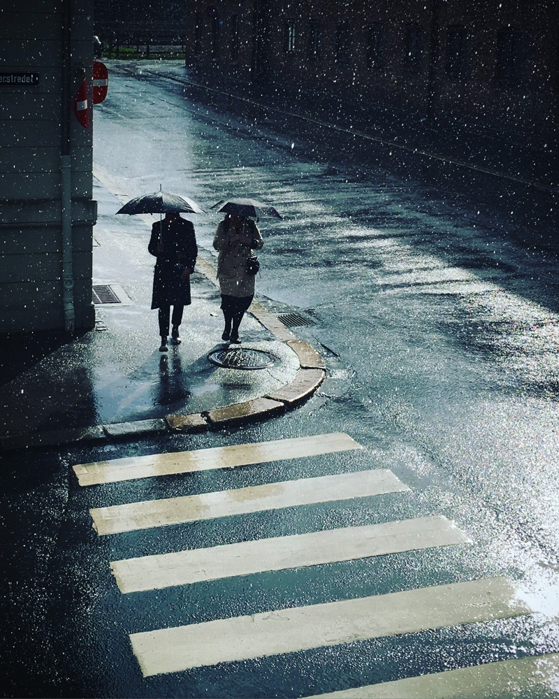 Et stemningsbilde tatt med mobil av to mennesker i regnværet fra Hanne C. Jonassens kontor.