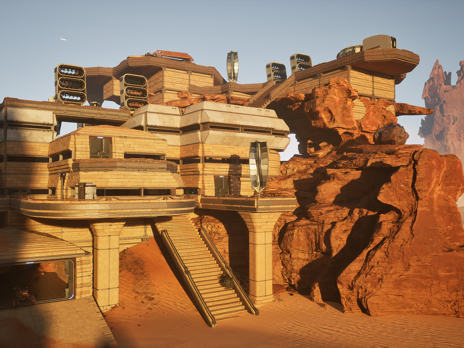 Digital rendering av et futuristisk bygg i et ørkenlandskap festet til en steinformasjon. 